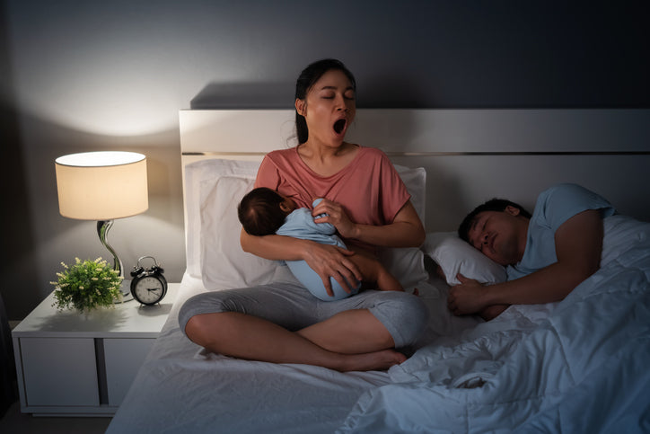 mother nursing baby at night