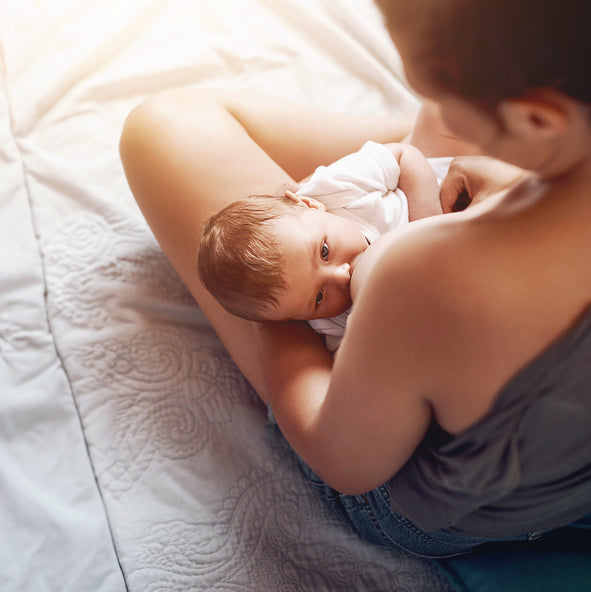 New mother soothing tender skin during breastfeeding using Dr. Nice’s Natural Products Nipple Care Gel.