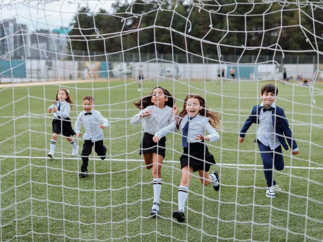 Kids running on a soccer field, representing active play, sports recovery, and safe first-aid care for children.